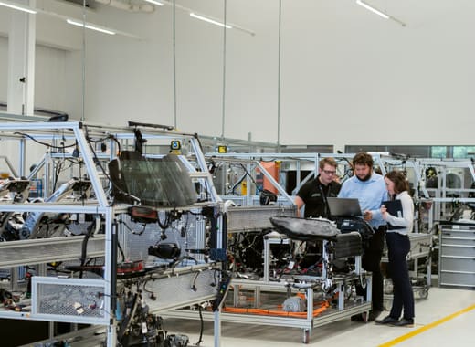 Engineers reviewing production data on a manufacturing floor